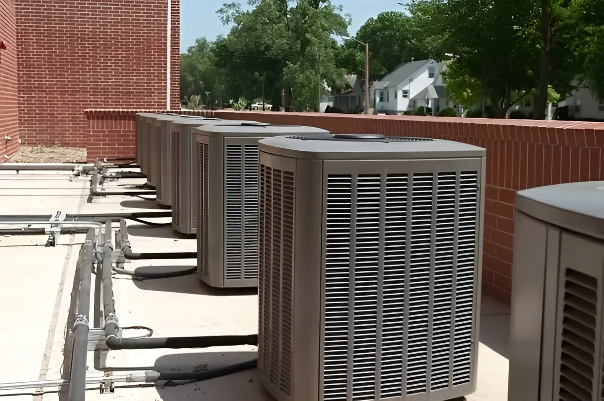 Licensed air conditioning contractor Los Angeles working on wall-mounted unit in apartment